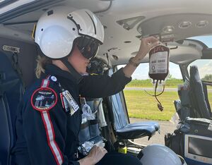 Air Methods Flight Nurse holding a unit of whole blood product. Air Methods Photo