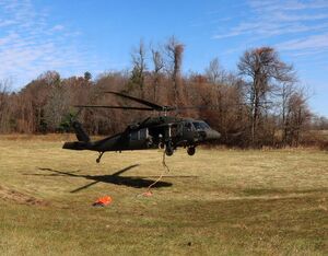 Two Virginia National Guard UH-60 Black Hawk helicopters equipped with 660-gallon water buckets provide aerial fire suppression support Saturday in Patrick County.  PROVIDED BY VIRGINIA NATIONAL GUARD
