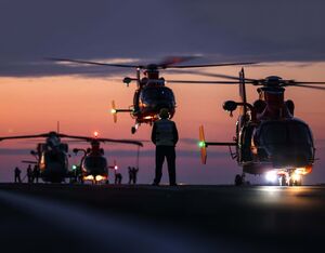 United States Coast Guard Dolphins conduct night flying with HMS Prince Of Wales. Royal Navy Photo