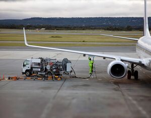 A fuel-pumping truck refueling a Boeing 737 from an in-ground pipeline (Photo by Tobias Titz via Getty Images)