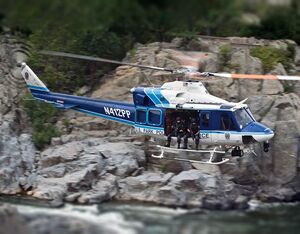 A Bell 412 helicopter from U.S. Park Police flies over water. Photos by Bell