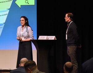 Savannah, left, and Brent Vlasman on stage during a recent conference presentation. Human Factors Survey Photo