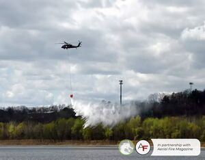 A New York Army National Guard Black Hawk helicopter drops water back into the Mohawk River while performing joint wildfire training exercises with state forest rangers on Monday at Colonie Town Park in Colonie. The bucket can carry 660 gallons of water.  Will Waldron/Times Union