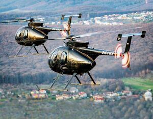 Two MD 500s belonging to the Slovak Training Academy fly over the Slovak countryside during a training flight. Lloyd Horgan Photo