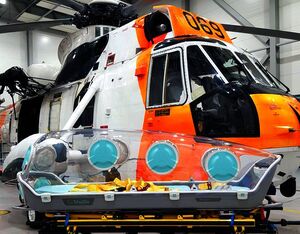A Royal Norwegian Air Force SH-3 Sea King search-and-rescue helicopter and an EpiShuttle incubator now in use to transport COVID-19 patients. 330 Squadron photo
