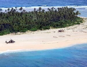 An Australian Army ARH Tiger helicopter lands on Pikelot Island in Micronesia. The SOS message of the stricken sailors can be seen on the beach. ADF photo
